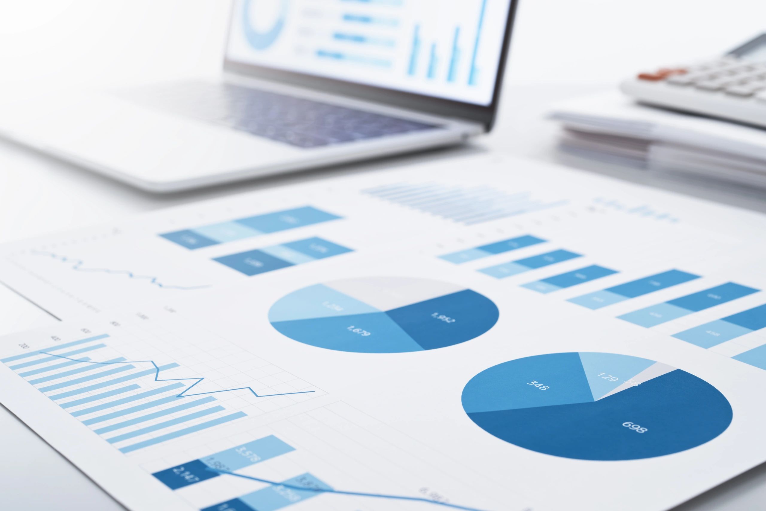 Marketing performance reports displayed on a laptop