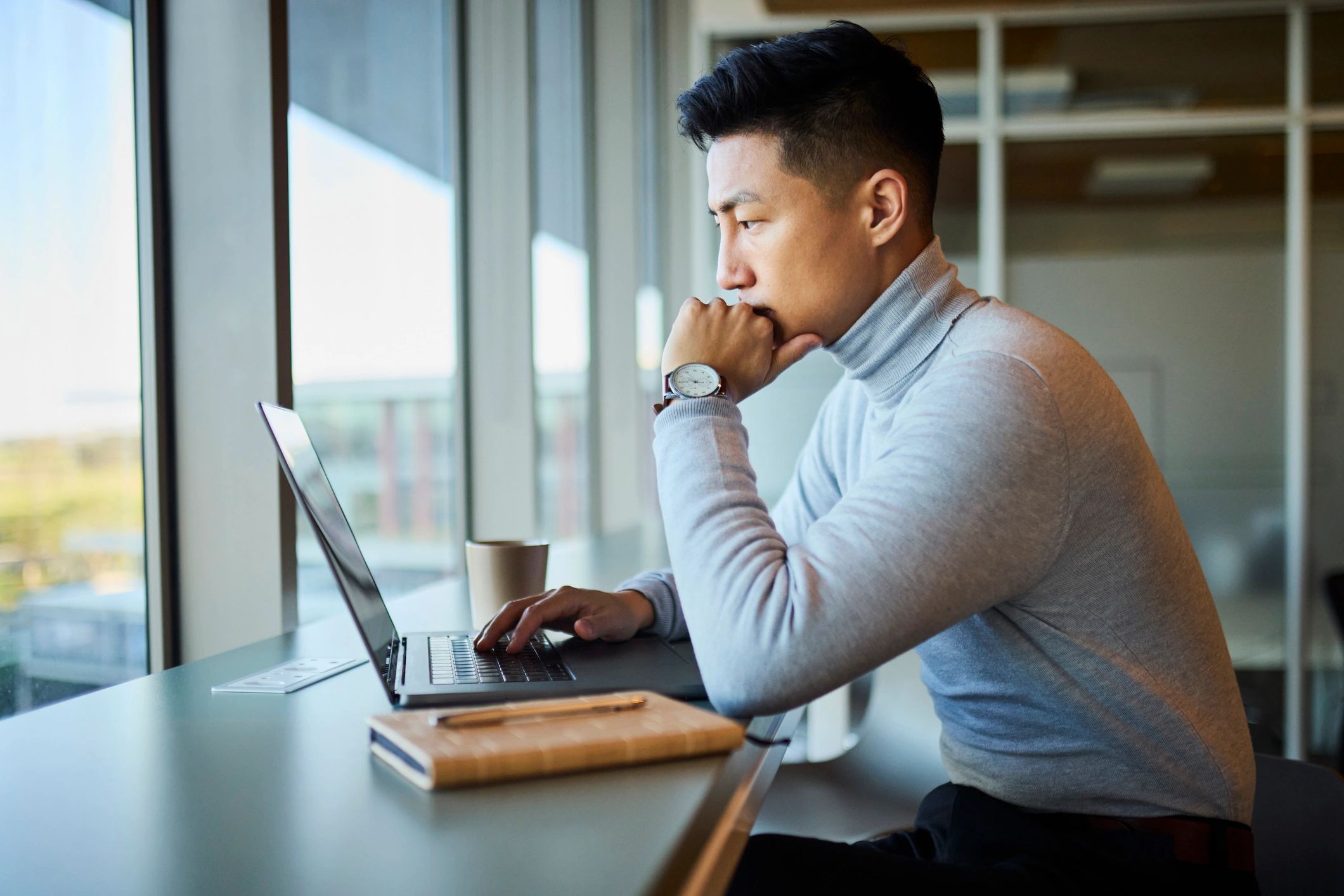 SEO consultant working on a laptop in a modern office